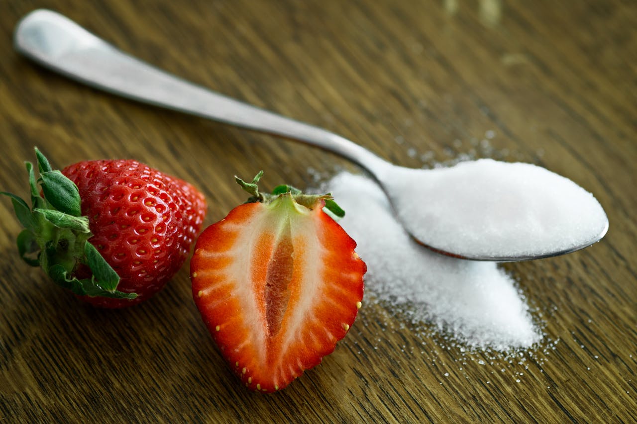 home-hero Close-up of fresh strawberries with sugar on a wooden table. Perfect for healthy dessert ideas.